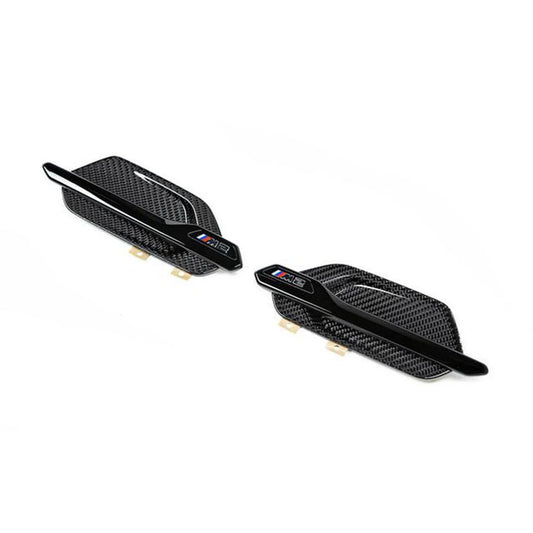 A pair of gloss carbon and gloss black front wing badges for BMW M2 and M2 Competition vehicles.