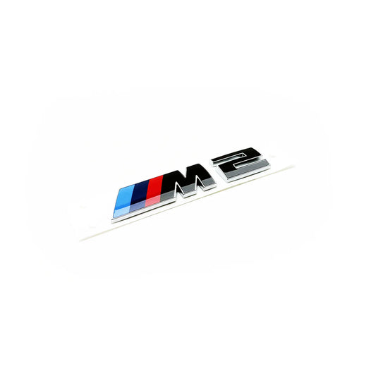 Genuine BMW Gloss black BMW M2 rear badge with silver outline and blue, red, and white colour stripes.